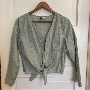 Embroidered floral eyelet button down shirt with long to quarter sleeves.